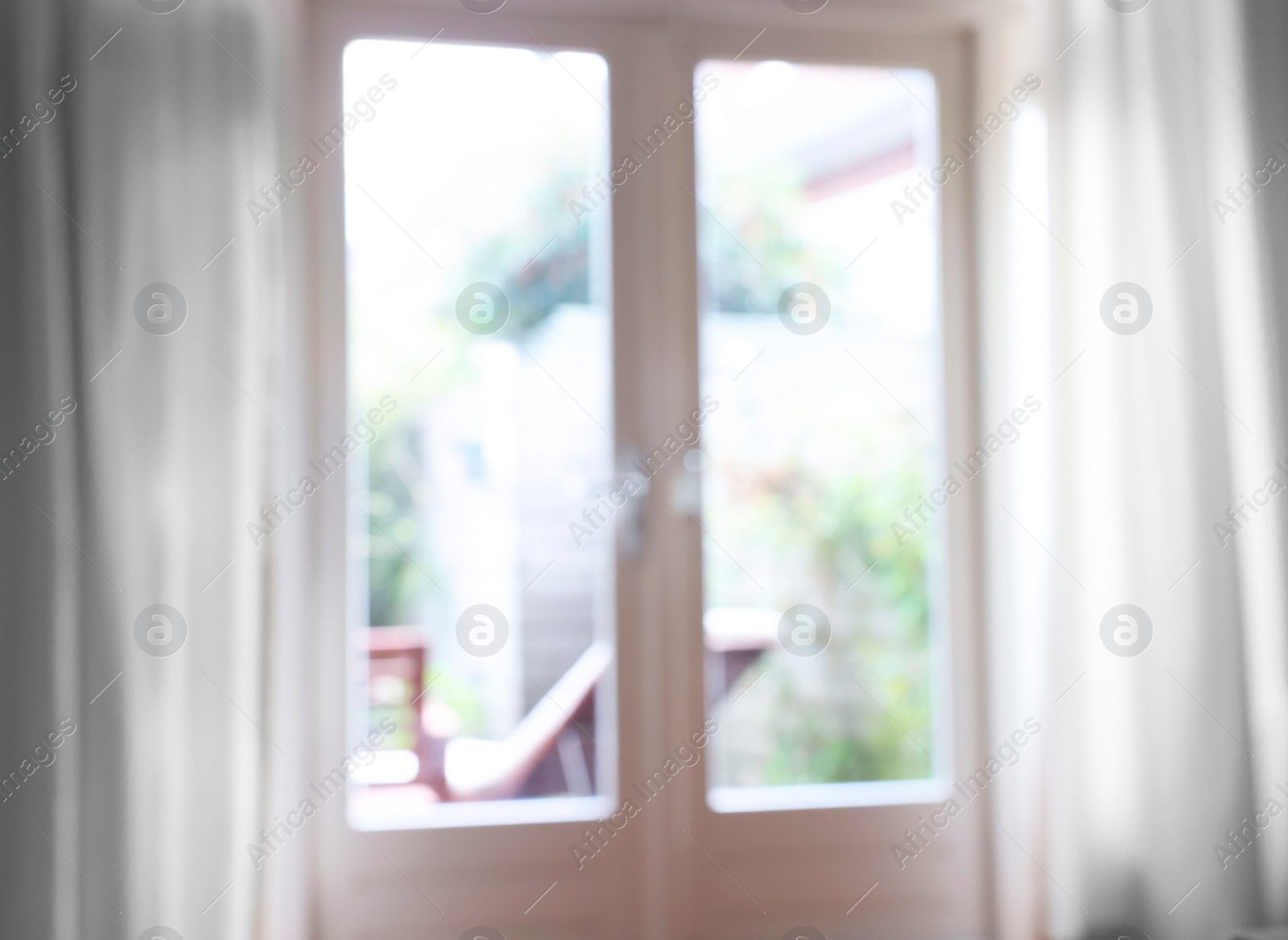 Photo of Blurred view of glass door at home