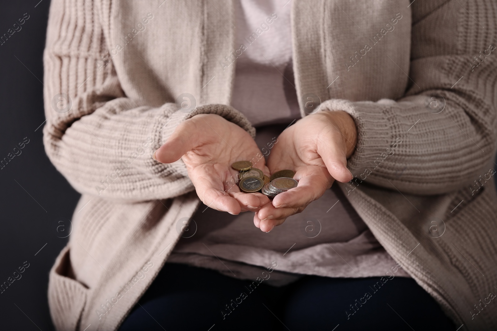 Photo of Poor elderly woman holding coins, focus on hands