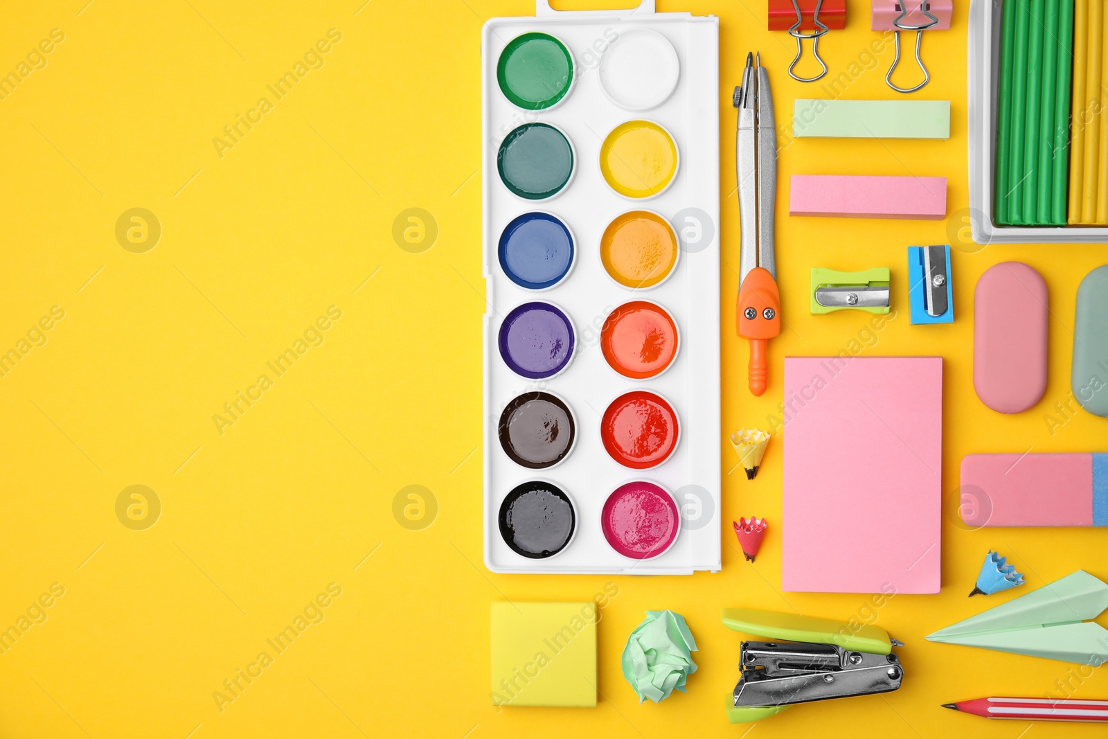 Photo of Flat lay composition with different school stationery on yellow background, space for text. Back to school