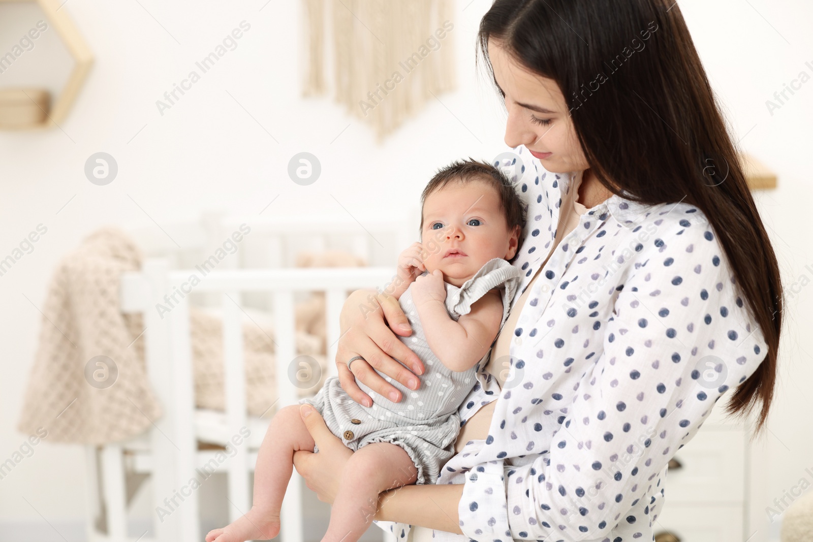 Photo of Mother with her cute newborn baby at home, space for text