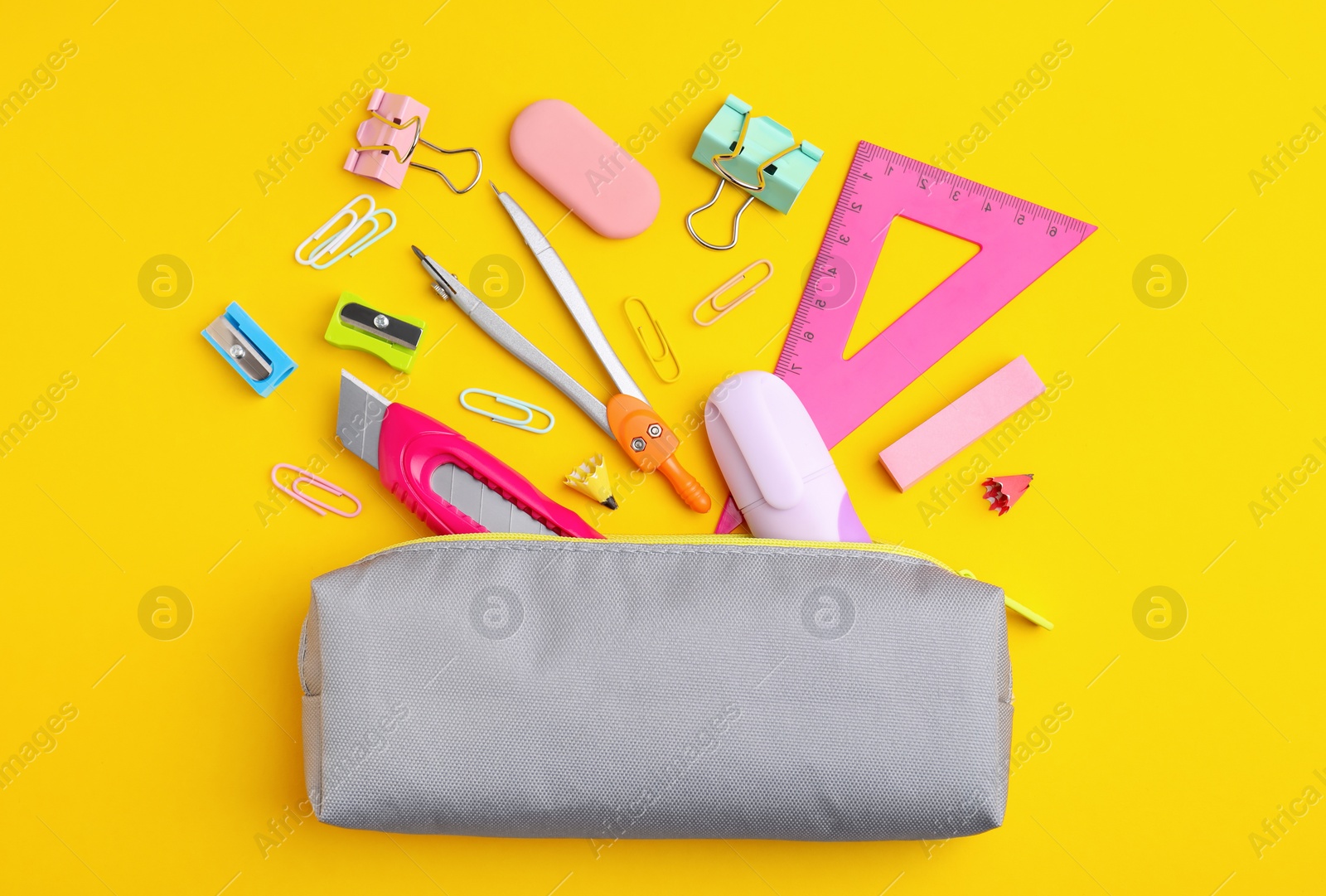 Photo of Flat lay composition with different school stationery on yellow background. Back to school