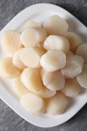 Photo of Fresh raw scallops on grey table, top view