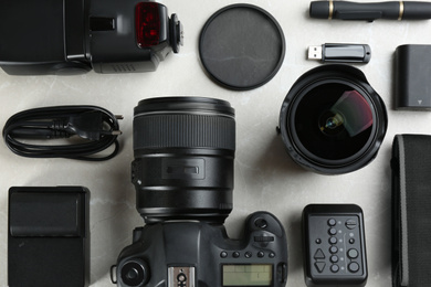 Photo of Flat lay composition with equipment for professional photographer on grey marble table