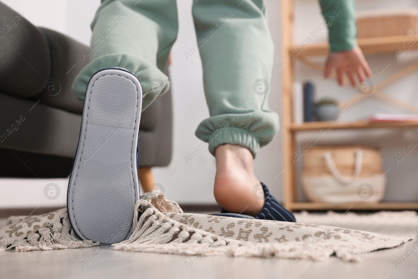 Photo of Man tripping over rug at home, closeup