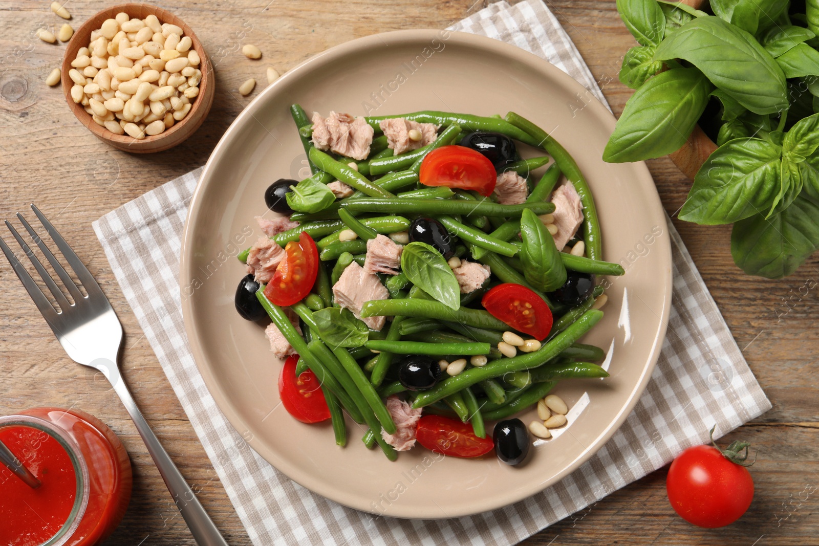 Photo of Tasty salad with green beans served on wooden table, flat lay