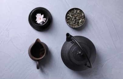Photo of Beautiful set for traditional tea ceremony on light grey table, flat lay