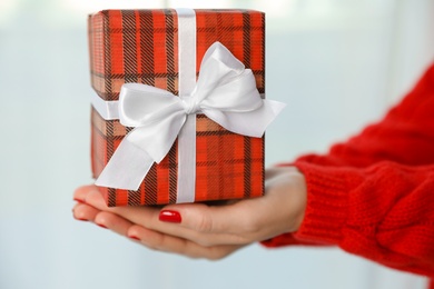 Photo of Woman holding gift box on white background, closeup. Christmas holiday