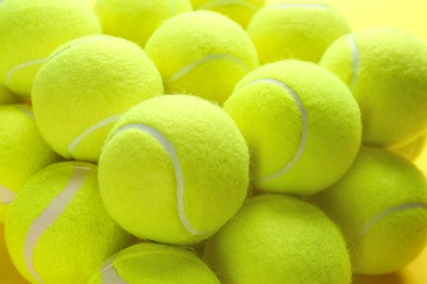 Photo of Bright tennis balls, closeup view. Sports equipment