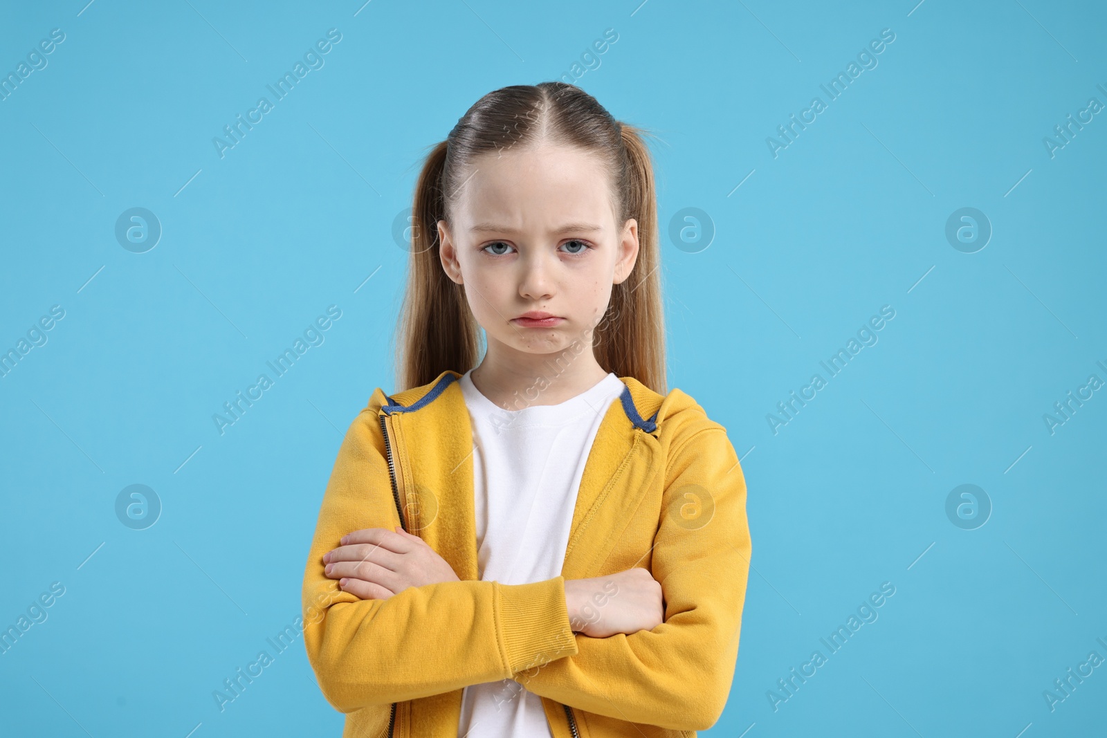 Photo of Portrait of sad girl on light blue background