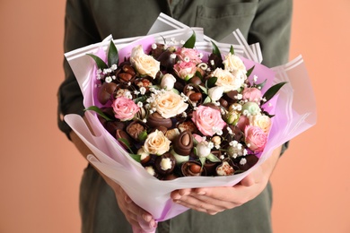 Woman with beautiful food bouquet on brown background, closeup