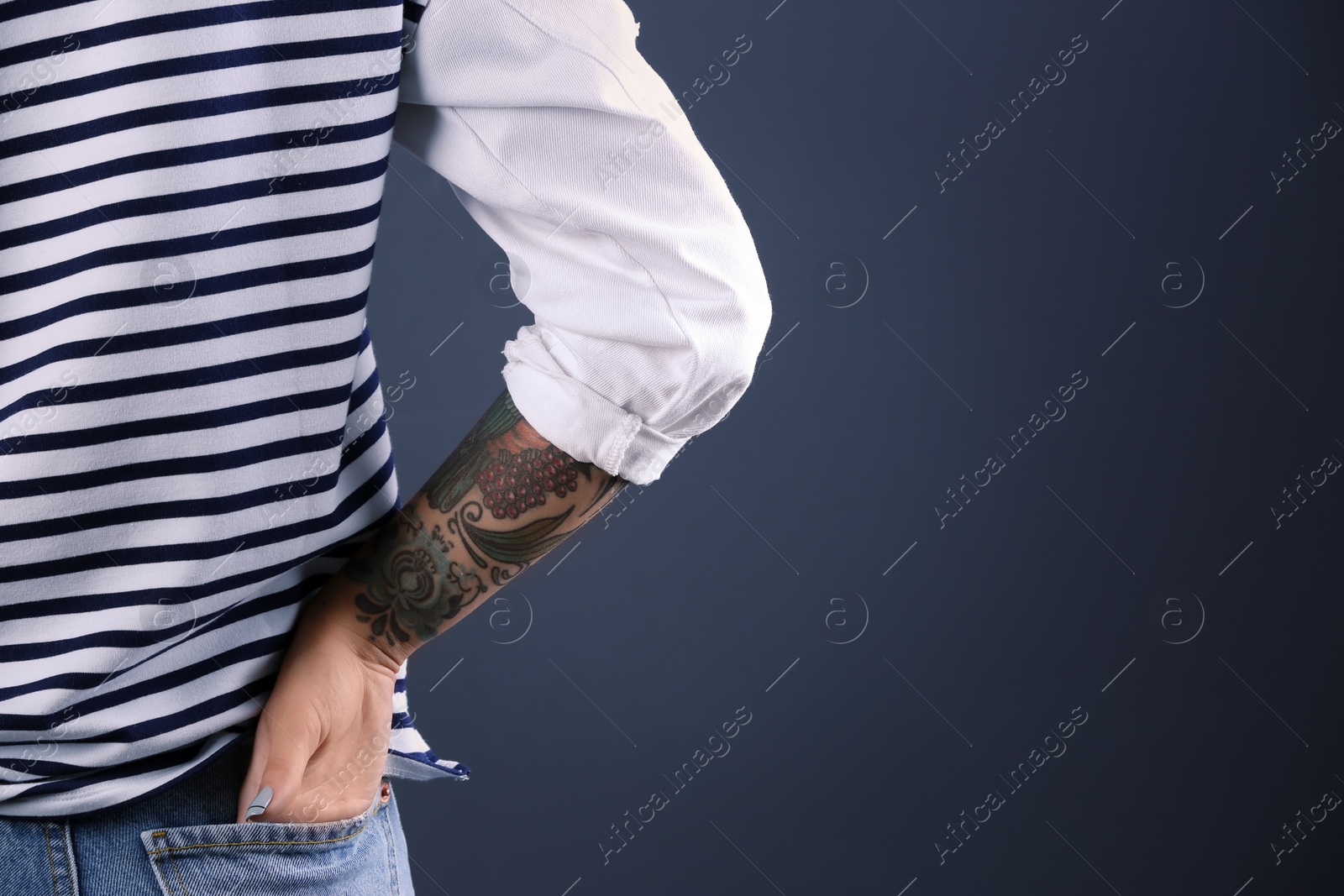 Photo of Trendy young woman with tattoo on color background, closeup. Space for text