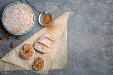 Photo of Flat lay composition with raw rye dough and almonds on grey background