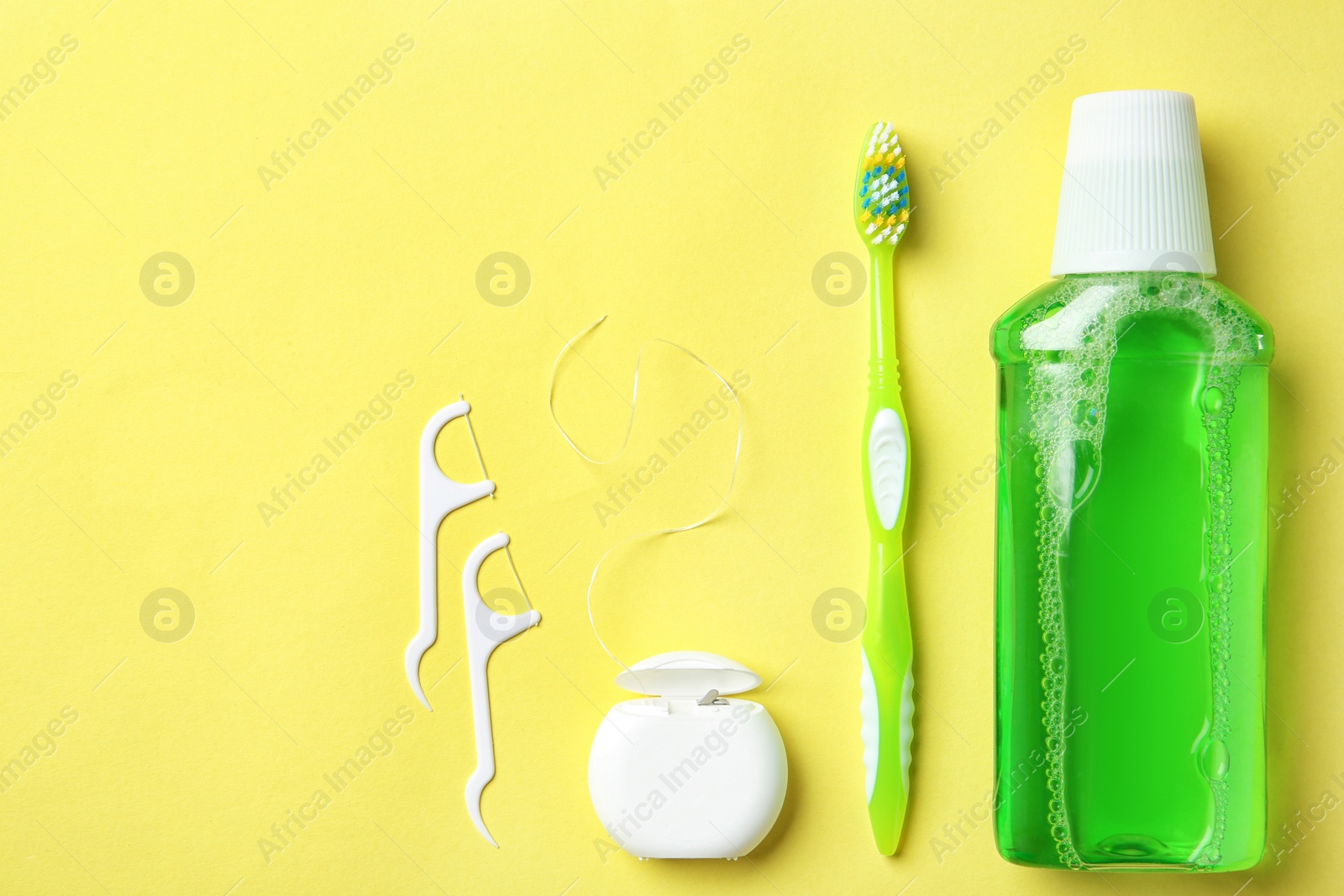 Photo of Flat lay composition with manual toothbrush and oral hygiene products on color background