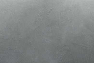 Photo of Light gray textured surface as background, top view