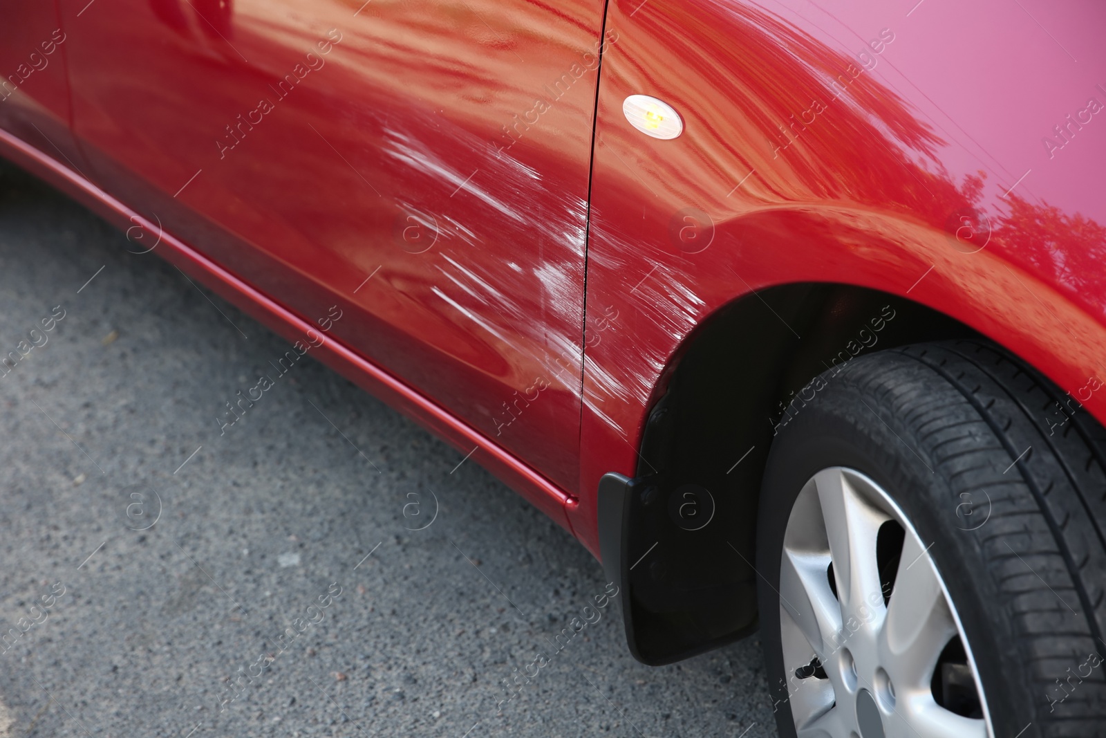 Photo of Modern red car with scratch outdoors, closeup