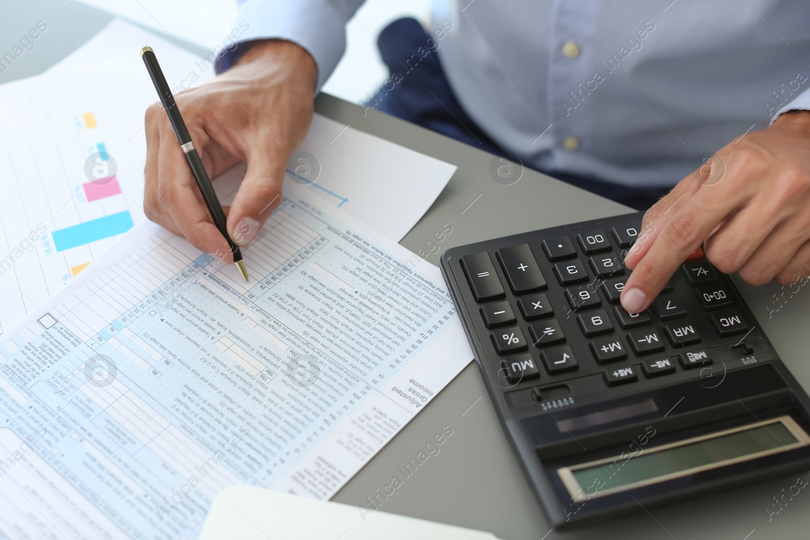 Photo of Tax accountant working with documents at table