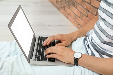 Man in casual clothes with laptop indoors