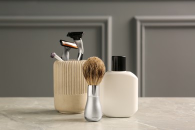 Photo of Set of men's shaving tools on grey marble table