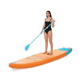 Happy woman with paddle on orange SUP board against white background
