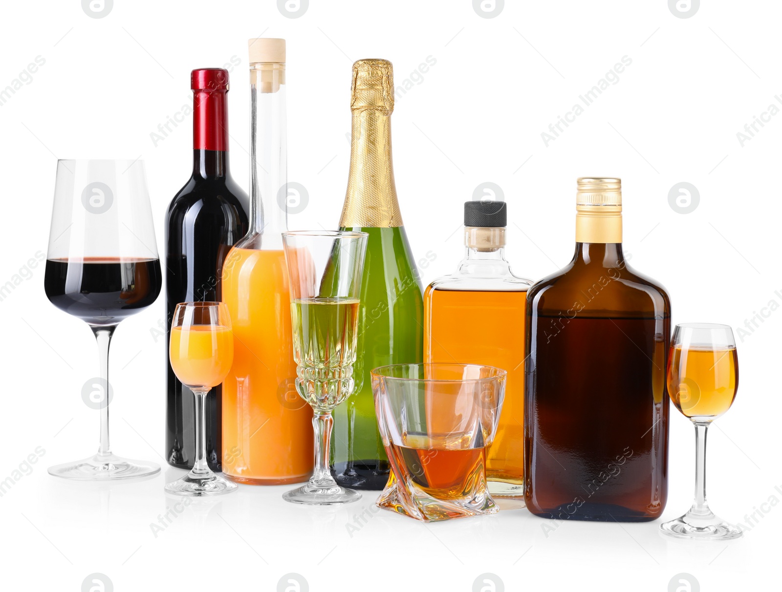 Photo of Bottles and glasses with different alcoholic drinks isolated on white