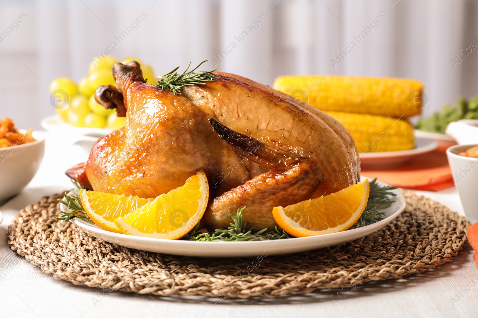 Photo of Delicious roasted turkey with garnish on dinner table