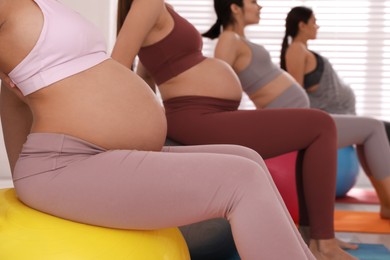 Photo of Group of pregnant women in gym, closeup. Preparation for child birth