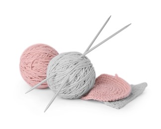Soft woolen yarns, knitting and needles on white background