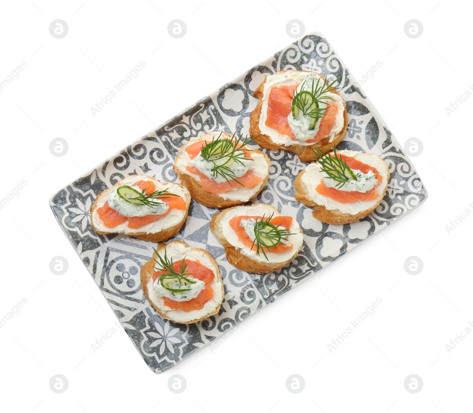 Photo of Tasty canapes with salmon, cucumber, cream cheese and dill isolated on white, top view