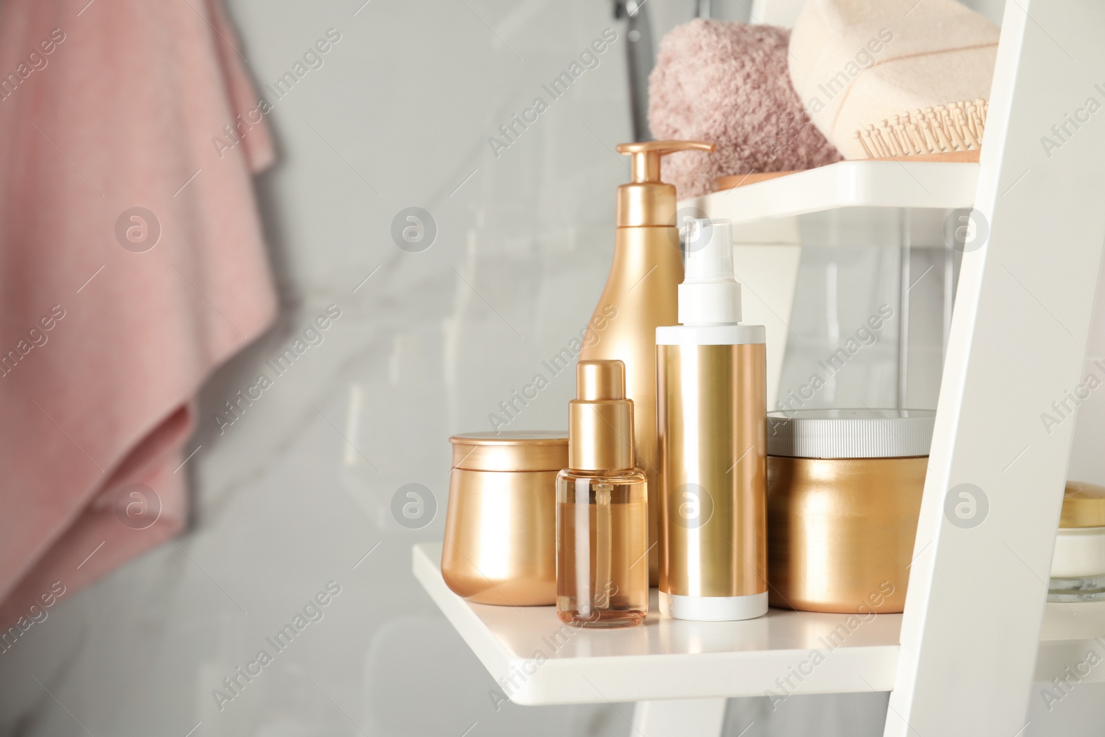 Photo of Set of hair care cosmetic products on white rack in bathroom. Space for text