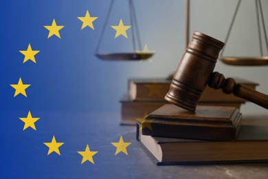 Image of Double exposure of European union flag and judge's gavel with book on table