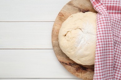 Fresh yeast dough with flour on white wooden table, top view. Space for text