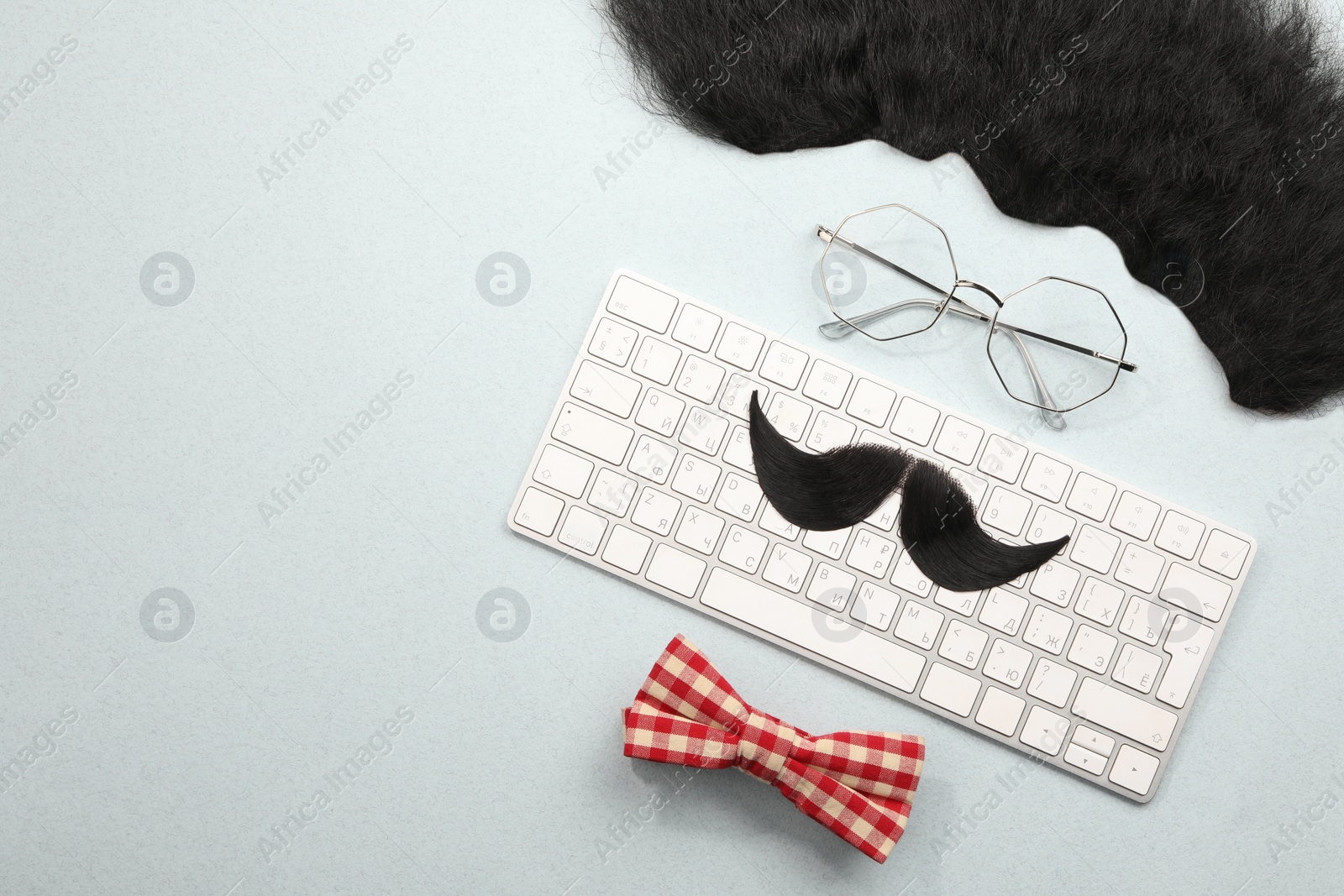 Photo of Flat lay composition with artificial moustache and glasses on light grey background, space for text