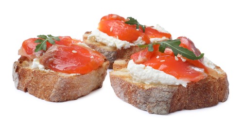 Delicious sandwiches with cream cheese, salmon and arugula on white background