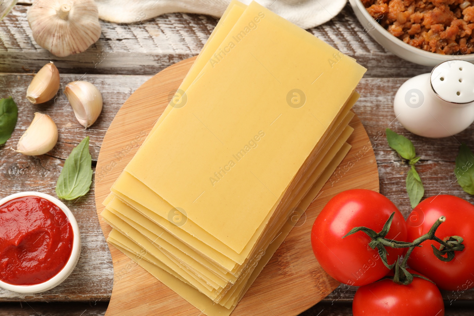 Photo of Flat lay composition with products for cooking lasagna on wooden rustic table