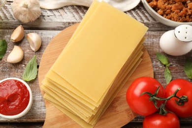 Flat lay composition with products for cooking lasagna on wooden rustic table