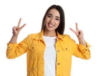 Photo of Woman in yellow jacket showing number four with her hands on white background