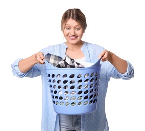 Emotional woman with basket full of laundry on white background