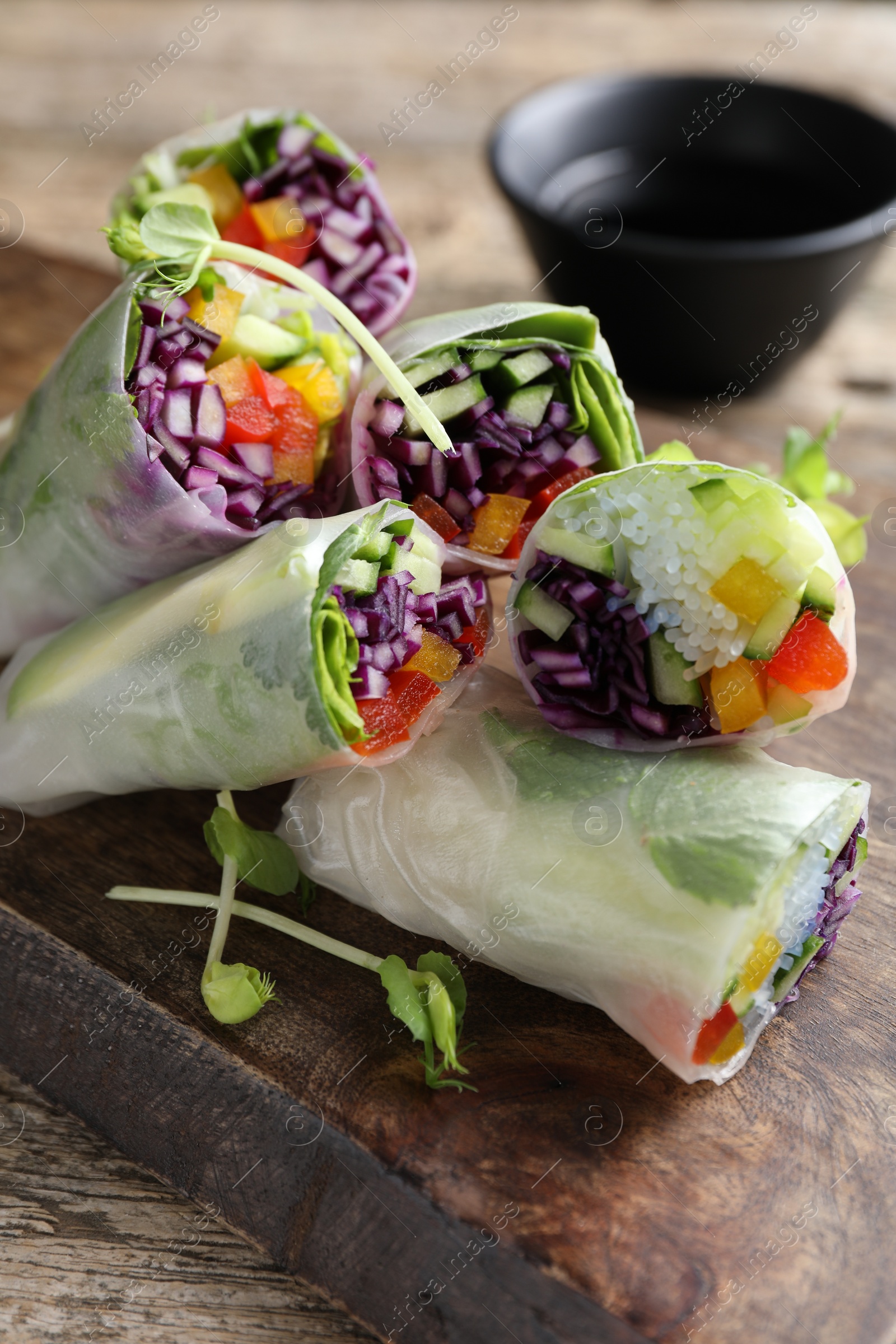 Photo of Delicious spring rolls on wooden table, closeup