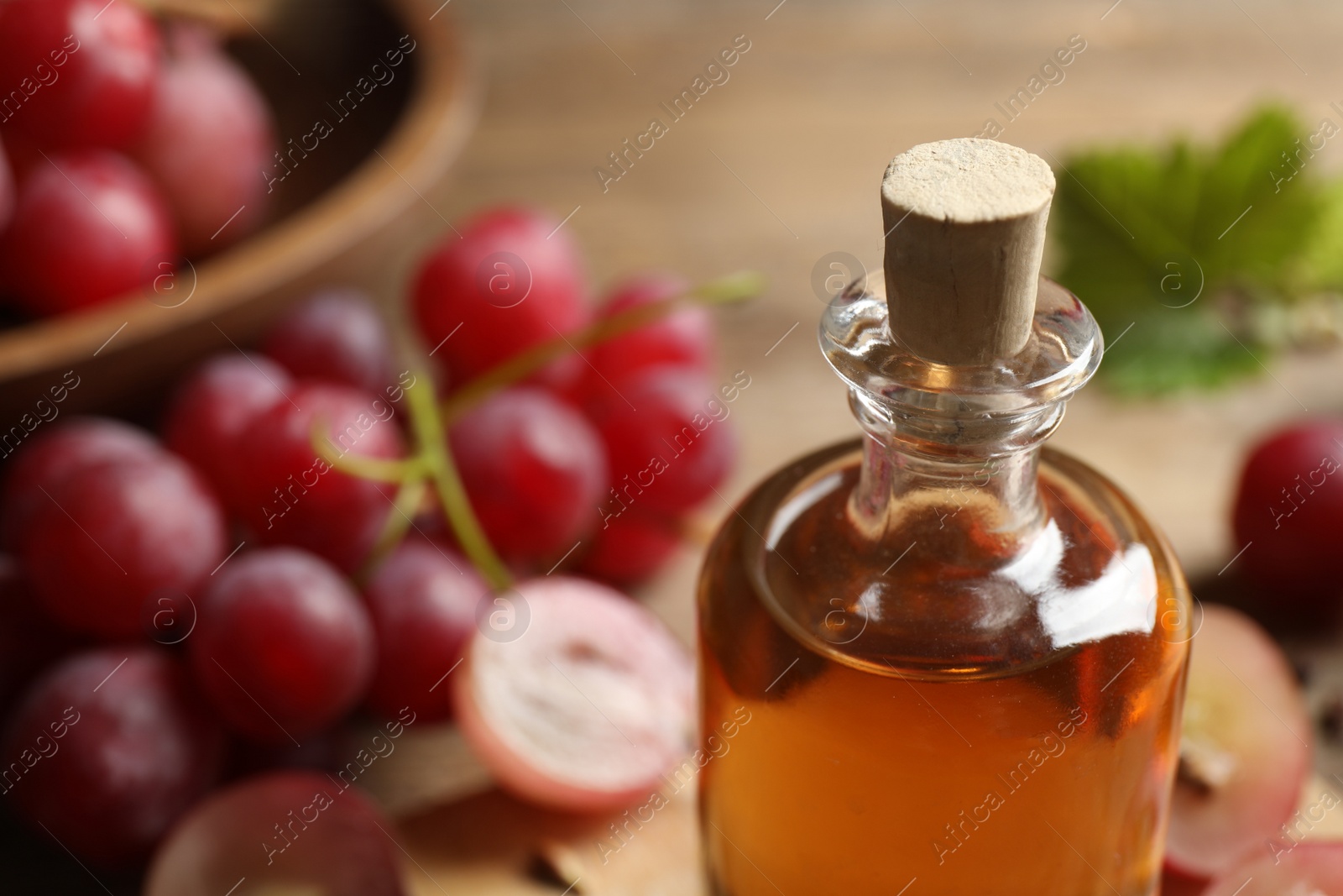 Photo of Bottle of natural grape seed oil, closeup with space for text. Organic cosmetic