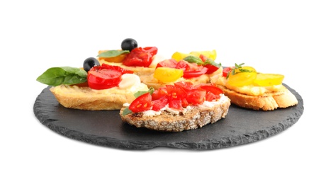 Photo of Slate plate of delicious tomato bruschettas on white background