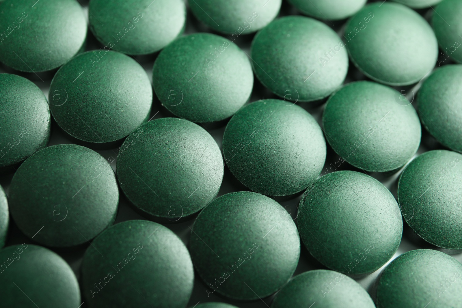 Photo of Closeup view of spirulina tablets on table