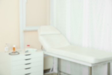 Photo of Blurred view of doctor's office interior with couch