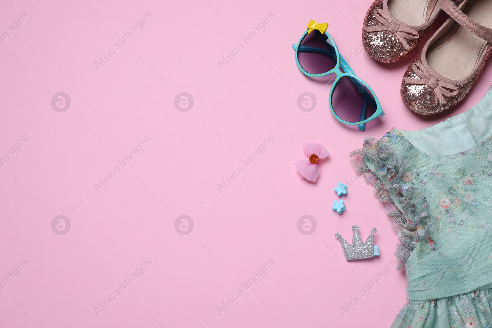 Photo of Flat lay composition with stylish child clothes and accessories on pink background, space for text