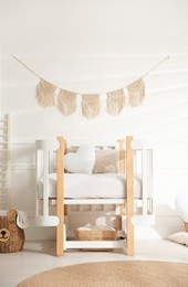 Photo of Baby room interior with stylish furniture and toys