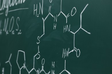 Photo of Chemical formulas written with chalk on green board