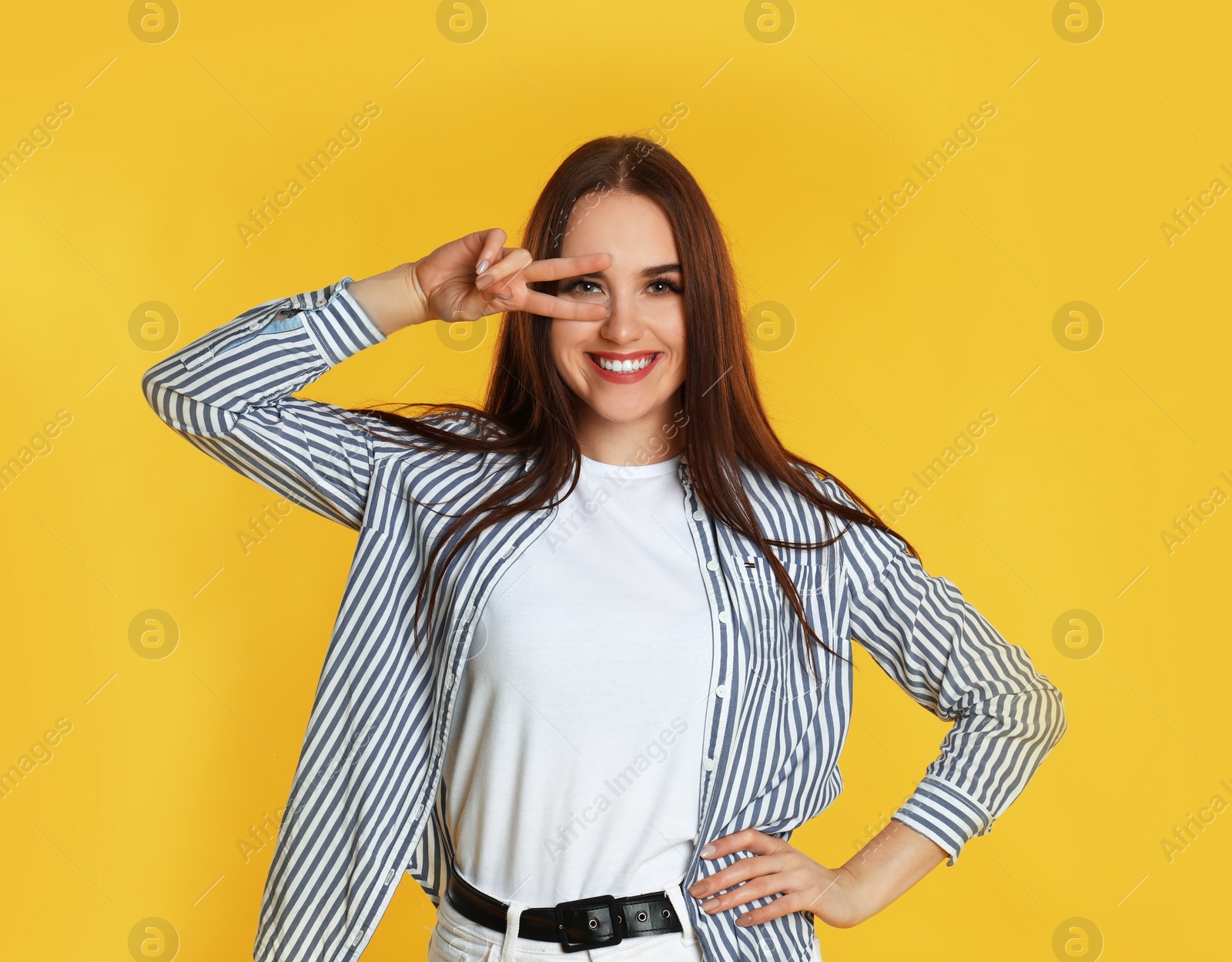 Photo of Portrait of happy woman on yellow background