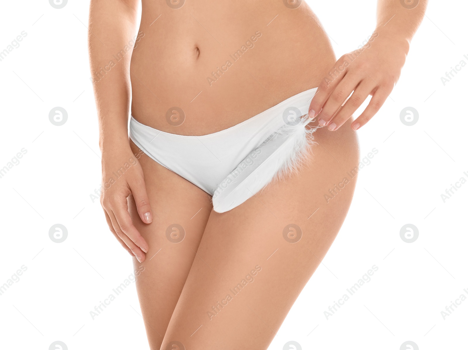 Photo of Woman with feather showing smooth skin on white background, closeup. Brazilian bikini epilation