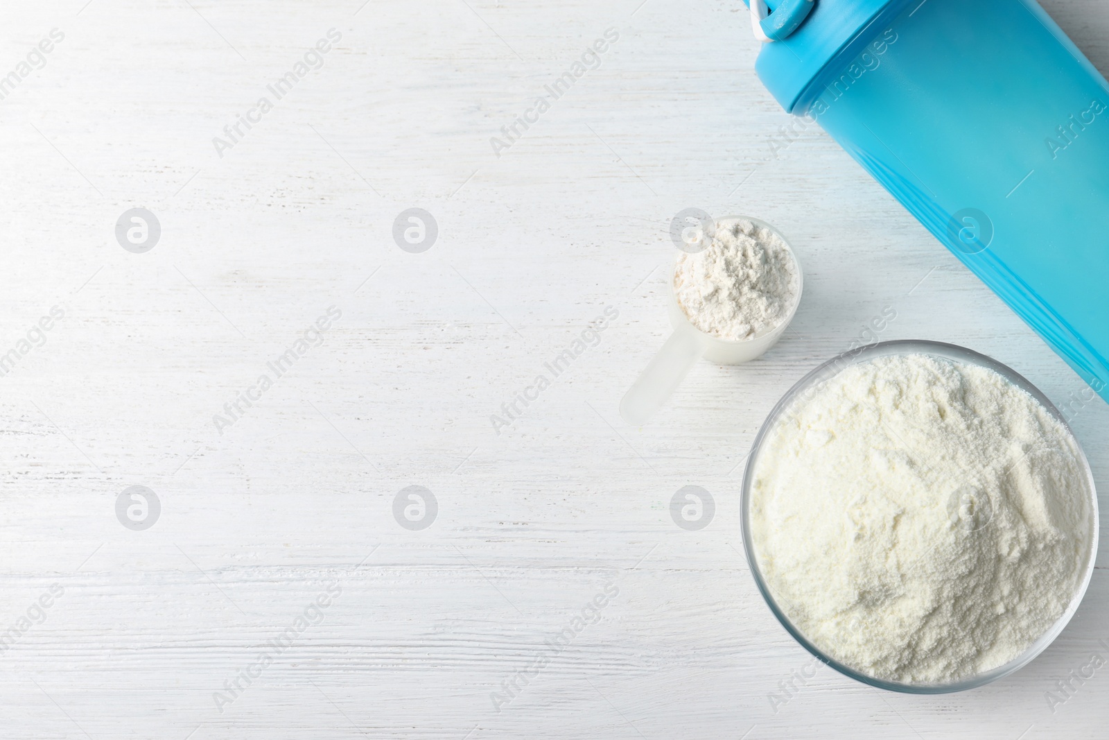 Photo of Flat lay composition with protein powder on white wooden table, space for text