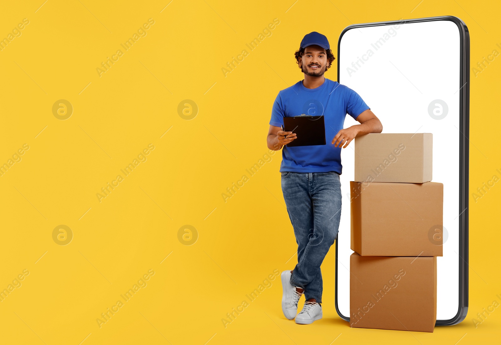 Image of Courier with stack of parcels and clipboard near huge smartphone on golden background. Delivery service. Space for text