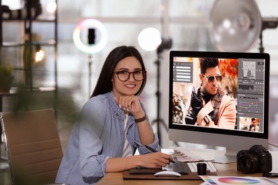 Photo of Professional retoucher working on computer in office